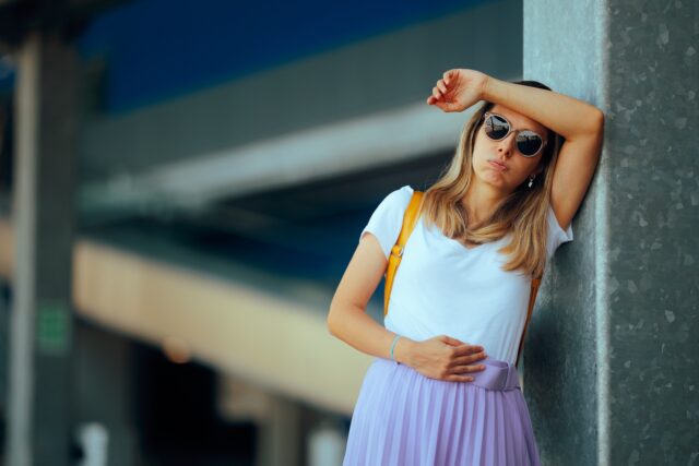 Unhappy,Tourist,Taking,A,Break,From,Her,Walk,Because,Of